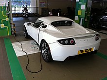 A Tesla Roadster charging at Central Star Ferry car park in Hong Kong. HK Central Star Ferry Multi-storey Carpark EV Electric Vehicle Charging white race automobile Dec-2012.JPG