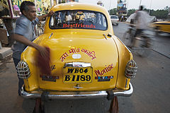 Taxi cab owner cleaning the car Calcutta Kolkata India