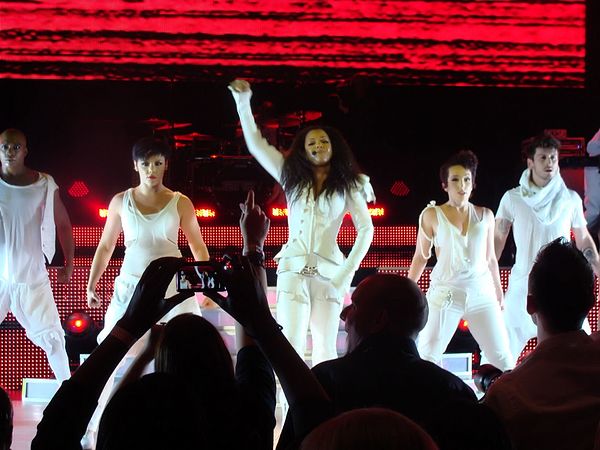 Jackson performing "Together Again" as the final song of her Number Ones, Up Close and Personal tour (2011).