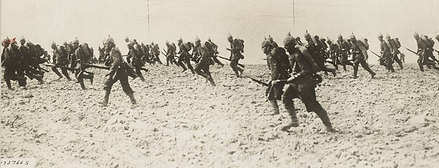 German infantry charging across open ground on the battlefield, 1914