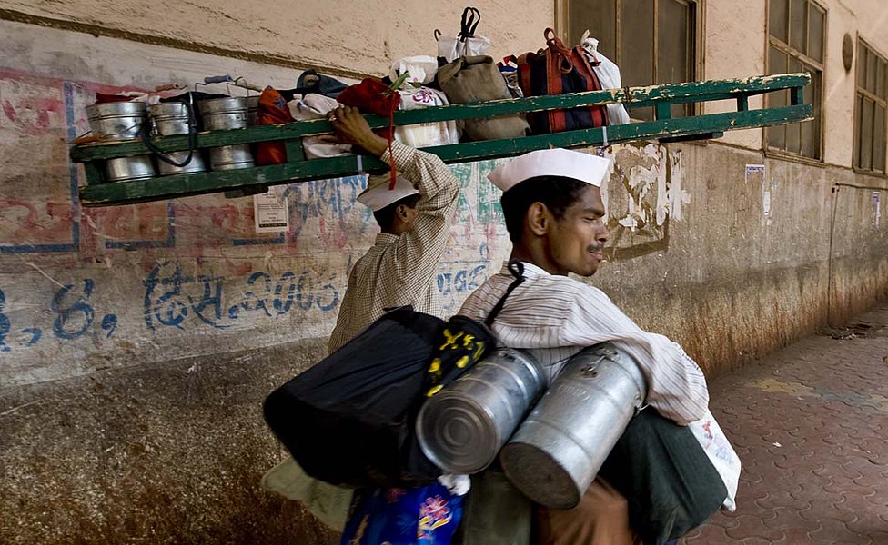 Two dabbawalas in Mumbai delivering meals packed in tiffin carriers