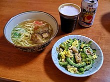 The plate to the right is the national dish, goya chanpuru, made with bitter melon known as goyain. Okinawa soba and goya chanpuru.jpg