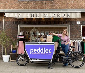 Peddler cargo bike in front of a partner store