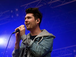 Lead vocalist Dan Smith singing into a microphone.