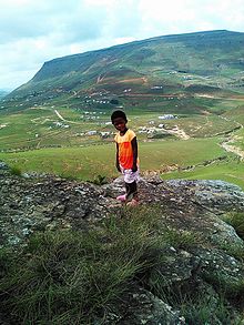 Photograph of the town of Qumbu in the background, with a local child in the foreground. Qumbu.jpg