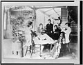 Robert Louis Stevenson with his family sitting around table at home in the Hawaiian Islands LCCN92504557.jpg