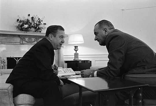 Senator Long confers with President Lyndon B. Johnson