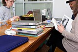 Researchers examining print materials during the Cornell University 2017 Art + Feminism Wikipedia edit-a-thon. Fine Arts Library, March 11, 2017.