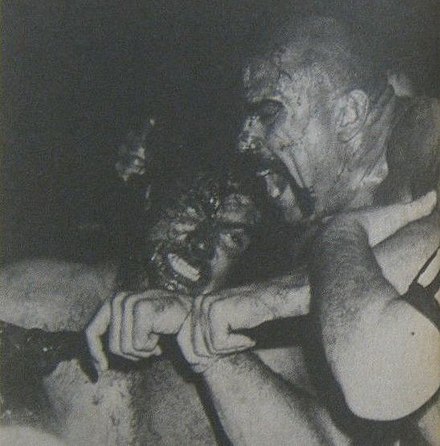 The Mongolian Stomper chewing on Don Muraco