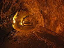 Photo of a smooth-walled natural tunnel through rock