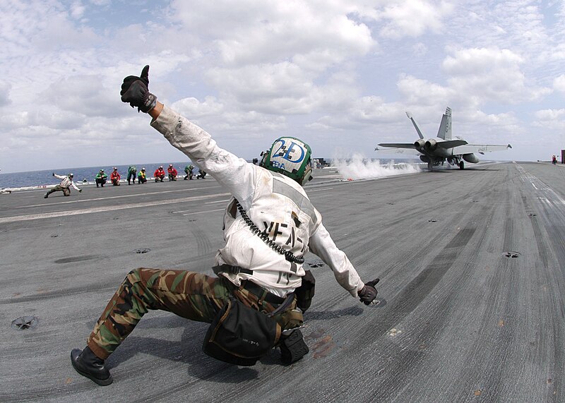 File:US Navy 060430-N-9946J-001 Aviation Machinist's Mate 3rd Class Joel Pena launches an F-A-18 Super Hornet.jpg