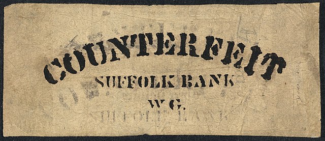A rectangular piece of paper. Counterfeit is printed on the top. "Suffolk Bank" is in the middle, above "WG"