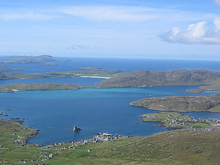 View of the Barra Isles from Heaval. The village of Castlebay is in the foreground, with Vatersay, and the uninhabited islands of Sandray, Pabbay, Mingulay and Berneray beyond.