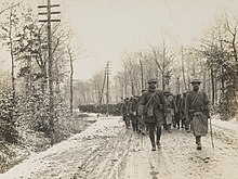 Men of Company D, 165th Infantry Regiment, 42nd Division, on hike from Benamenil, France, to a rest camp at Chenevieres, March 1, 1918. 111-SC-7652 - Company D, 166th (4th Regiment Infantry, Ohio National Guard) Infantry, on hike to rest camp at Chenevieres, France- - NARA - 55176086 (cropped) (cropped).jpg