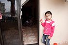 A girl waits outside a gender-based violence support session for Syrian refugee women in Lebanon (11173716145).jpg