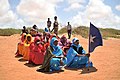 A young woman holds the Somali flag during a demonstration by a local militia, formed to provide security in Marka, Somalia, on April 30. AU UN IST PHOTO - Tobin Jones (13894459768).jpg