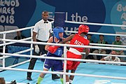 Deutsch: Boxen bei den Olympischen Jugendspielen 2018 Tag 12, 18. Oktober 2018 - Finale Fliegengewicht Mädchen – Martina La Piana (Italien, blau) schlägt Adijat Gbadamosi (Nigeria, rot) 5-0; Ringrichter ist James Beckles (Trinidad und Tobago). English: Boxing at the 2018 Summer Youth Olympics on 18 October 2018 – Girl's flyweight Gold Medal Bout - Martina La Piana (Italy, blue) beats Adijat Gbadamosi (Nigeria, red) 5-0; Referee is James Beckles (Trinidad and Tobago). Español: Boxeo en los Juegos Olímpicos Juveniles de Verano de 2018 en 18 de octubre de 2018 - Combate a medalla de oro de peso mosca para mujeres: Martina La Piana (Italia, azul) le gana a Adijat Gbadamosi (Nigeria, roja) 5-0; El árbitro es James Beckles (Trinidad y Tobago).