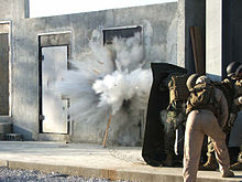 U.S. Marines using an explosive charge to breach a door Breach.jpg