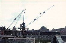 Old photograph of a crane on the quayside.