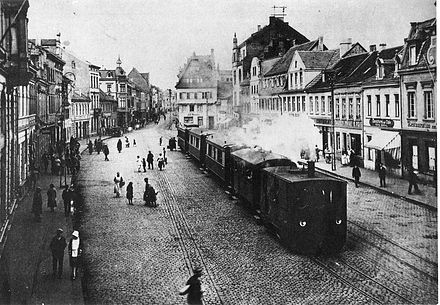 A steam tram engine from the Cologne-Bonn Railway, pulling a train through Brühl marketplace, c. 1900