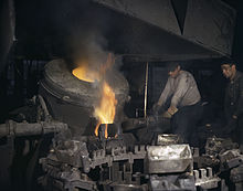 Workers in Euclid during World War II Casting a billet from an electric furnace at Chase Brass and Copper Co - Euclid Ohio.jpg