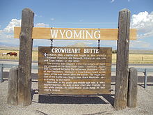 A sign in front of nearby Crowheart Butte explains how the geological feature got its name.