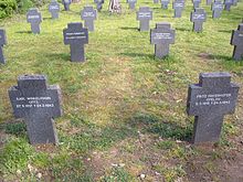 German Military Cemetery in Cuacos de Yuste. In the foreground, the graves of two of members of the submarine crew. In 1983, all the German soldiers and sailors buried in Spain from the WWI and WWII were exhumed from their graves and buried in this cemetery. The corpses of the U-77 were taken from the cemetery of Alicante to their final resting place in Cuacos. Cuacos de Yuste - Cementerio Militar Aleman 19.jpg