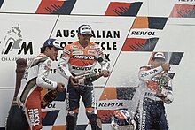 Daryl Beattie, Mick Doohan and Alex Criville, spraying the champagne on the podium after finishing second, first and third at the 500cc race. Daryl Beattie, Mick Doohan and Alex Criville 1995 Eastern Creek.jpg