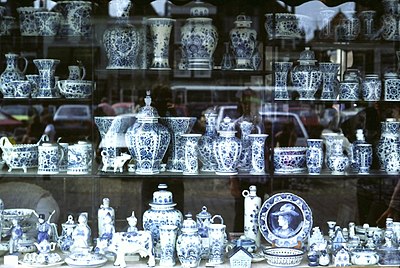 Shop window display of Delftware in the market place, Delft. East Asian–inspired Delftware, a lasting cultural and economic legacy of the VOC era.