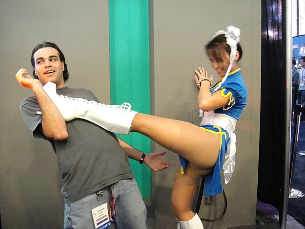 A Chun-Li promotional model posing at the E3 2011 Capcom booth