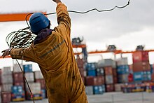 Filipino seaman throwing heaving line with monkey fist. Filipino seaman.jpg