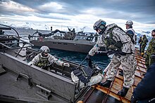 Finnish Marines load gear into a Swedish CB90-class (2024) Finnish Marines load gear into a Swedish CB90-class fast assault craft from the stern gate of USS Gunston Hall during Steadfast Defender 2024.jpg