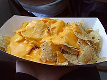Nachos with a processed cheese sauce (nacho cheese) Flickr jennerosity 3399911471--Nachos.jpg