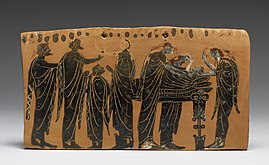 A terracotta plaque depicting the dead body being displayed, surrounded by family with women tearing out their hair in mourning. Gela Painter - Black-Figure "Pinax" (Plaque) - Walters 48225.jpg