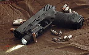 Glock 22 surrounded by .40 Hydra-shok bullets.jpg