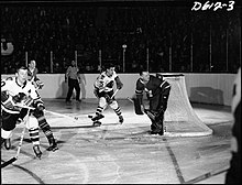 Johnny Bower (in net) during a game against the Black Hawks. Bower was the Maple Leafs' goaltender from 1958 to 1969. He helped the team win four Cups.