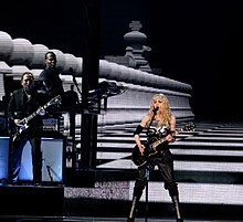 Madonna performing a rock version of "Hung Up" during the 2008 leg of the Sticky & Sweet Tour Hungupsticky (cropped).jpg