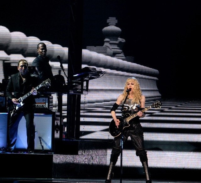 Madonna performing a rock version of "Hung Up" during the 2008 leg of the Sticky & Sweet Tour