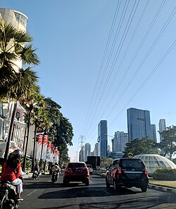 Mayjen Jono Sewojo road. Fairway Nine is at the left and Pakuwon Mall is on the right of the image, with its six towers. Behind Pakuwon Mall is Ascott Waterplace, a residential complex, with five towers. The camera is facing south.