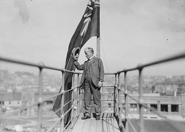 Bradfield doffing his hat to onlookers from the newly constructed Sydney Harbour Bridge