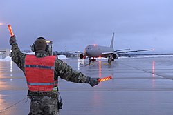 An airman marshalling a 157th Air Refueling Wing KC-46A Pegasus at Pease ANGB in February 2020
