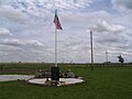 Longer shot of the memorial, showing the flagpole also built at the site.