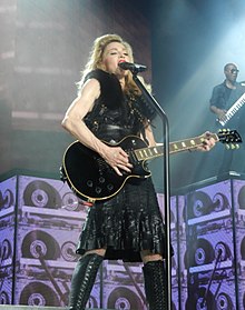 Madonna performing "Turn Up the Radio" during the opening night of The MDNA Tour on May 31, 2012 MDNASCN1178 (7329129658) (cropped).jpg