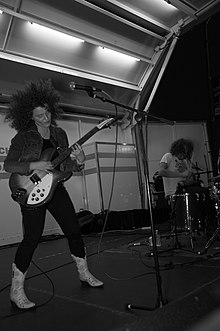 Miss Alex White (left) playing guitar with her band White Mystery Milwaukee Ave Arts Festival (3787822114).jpg