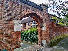 The former entrance gateway still stands and is Grade II-listed. Oatlands Palace gateway, Weybridge, Surrey.jpg