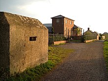 A pillbox which formed part of the Taunton Stop Line, with Creech engine house, Charlton, in the background Pillbox and engine house.jpg