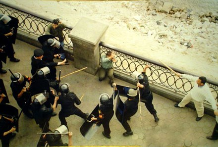 Nine police officers subduing a member of the public in Egypt