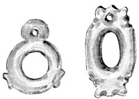 Two samples of a greenstone leg ring for a parrot or kaka. One on the left is circular and the right one is more oval shaped. The smaller ring at the top is for a flax cord to passed to secure the bird to its perch.