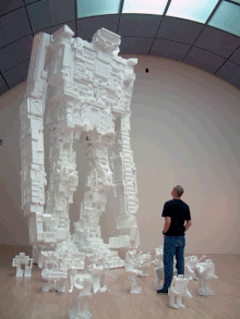 Artist Michael Salter contemplates his giant Styrobot at the San Jose Museum of Art. Salter2.gif