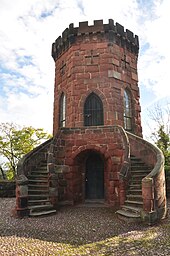 An octagonal tower with large windows, built of Old Red Sandstone